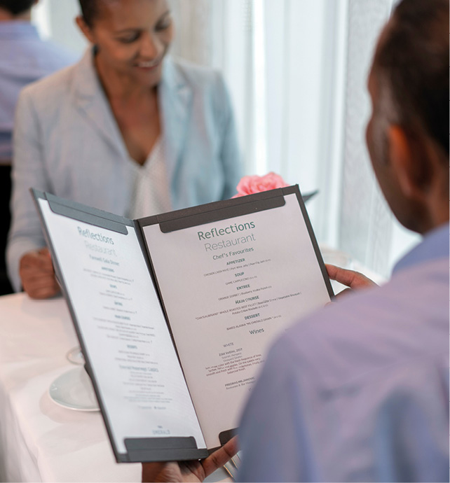 A couple reading the restaurant dinner menu