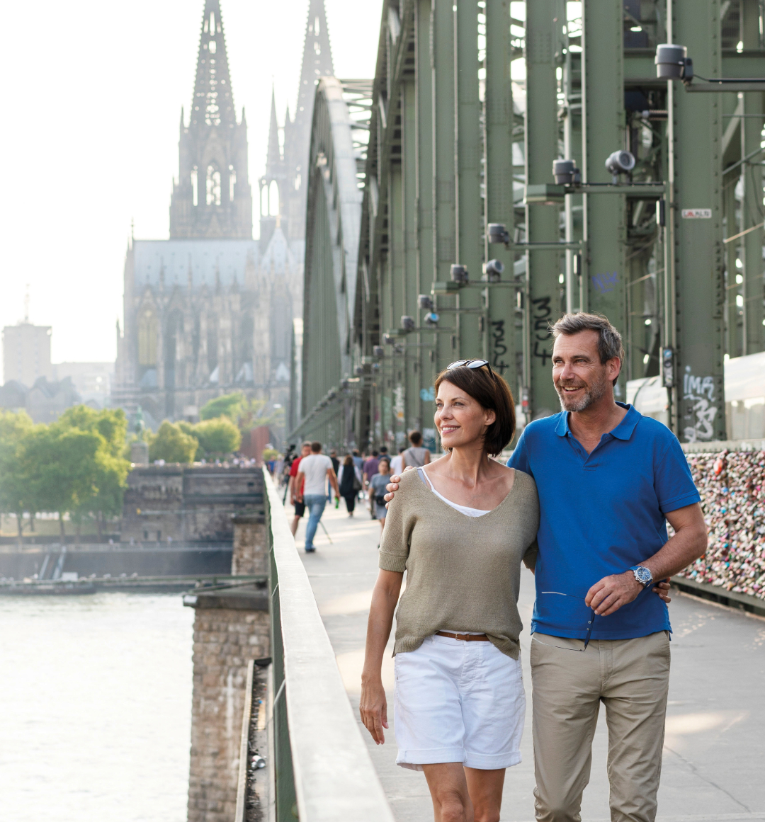 A couple walking over Hohenzollern Bridge in Cologne Germany