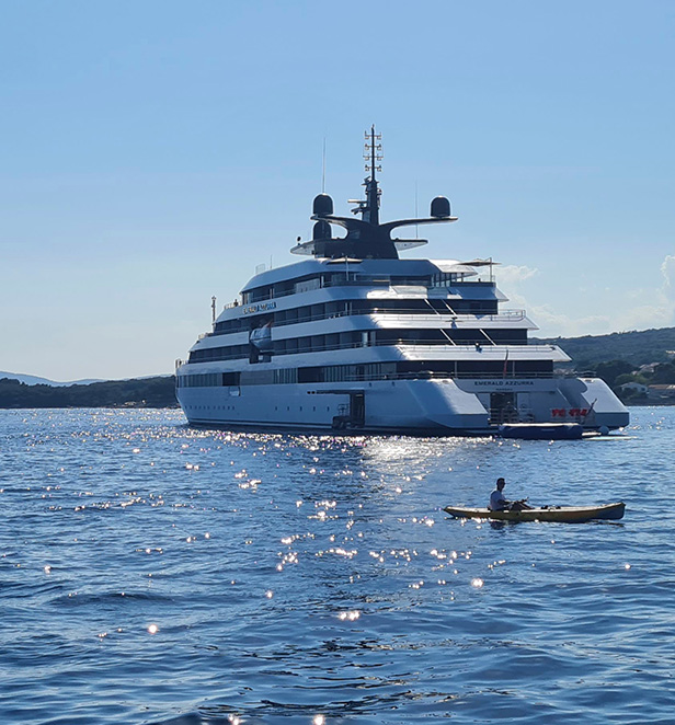 Emerald yacht guests paddleboarding