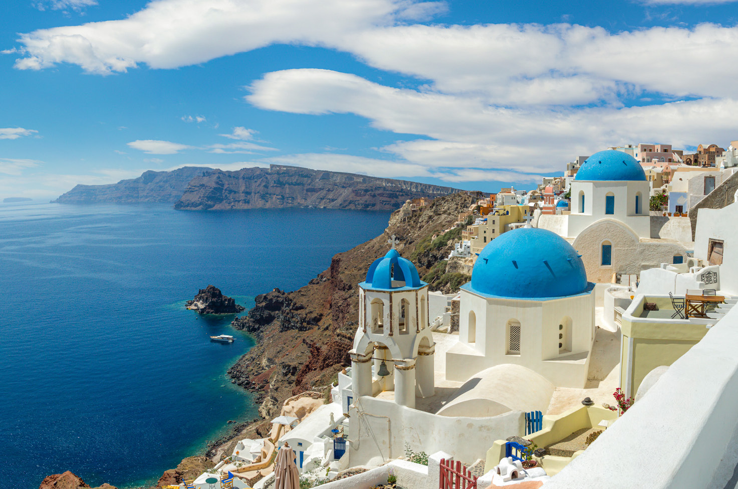 Hillside view of blue and white buildings in Santorini Greece