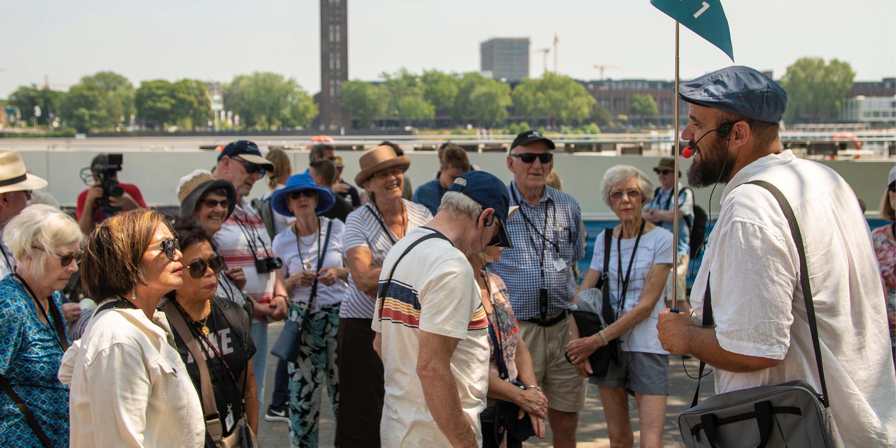 A group of tourists following a tour guide as they explore the city of Cologne, Germany