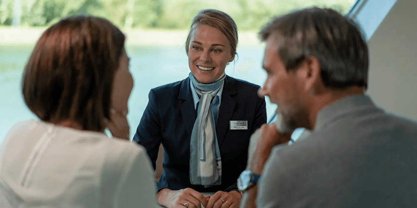Friendly crew member helping guests on board a luxury river cruise