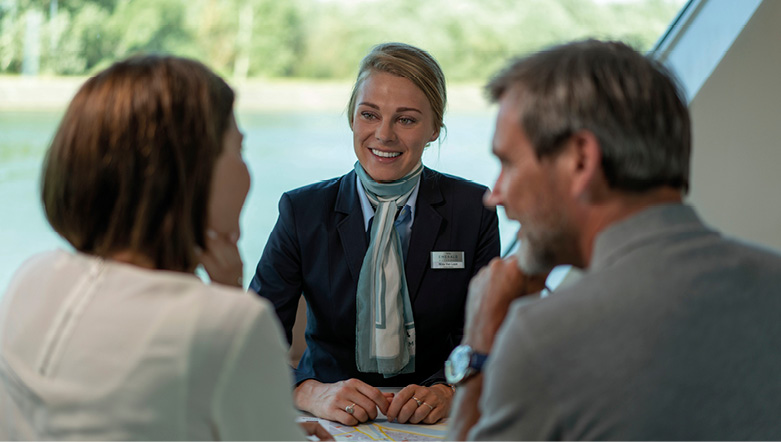 Cruise director helping guests on board a luxury river ship in Europe