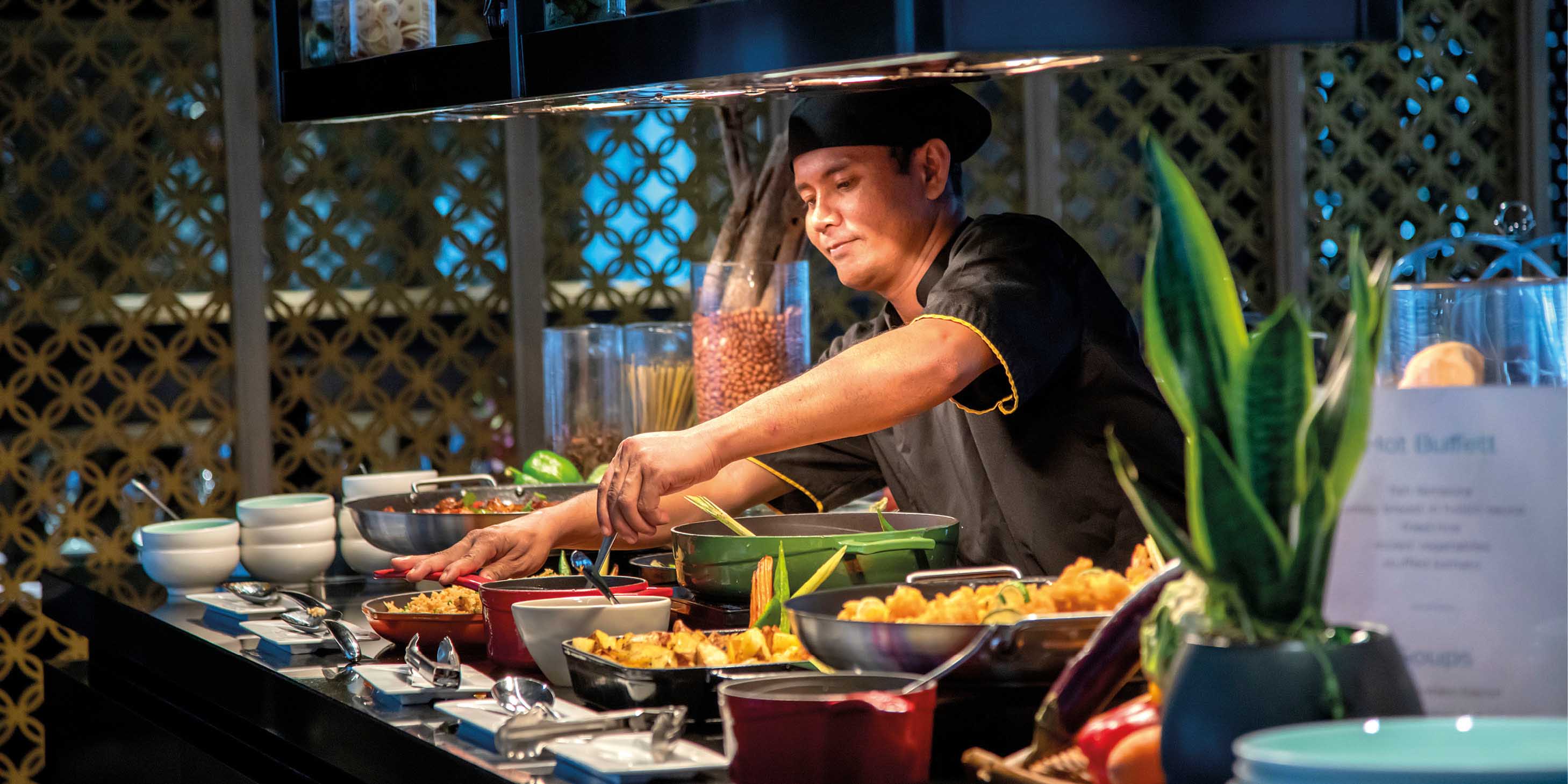 Chef serving up delicious Asian inspired food on board a luxury river ship in Southeast Asia
